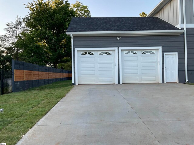 garage featuring a lawn