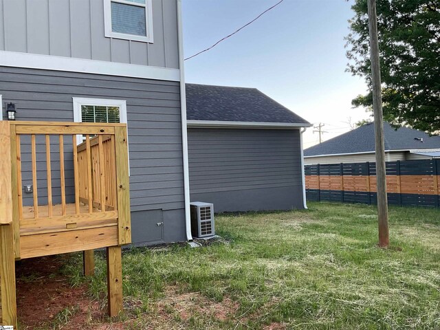 view of home's exterior with a yard and central air condition unit