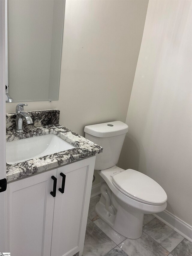 bathroom featuring large vanity, toilet, and tile flooring