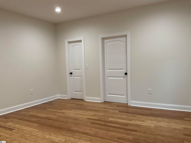 empty room with hardwood / wood-style flooring