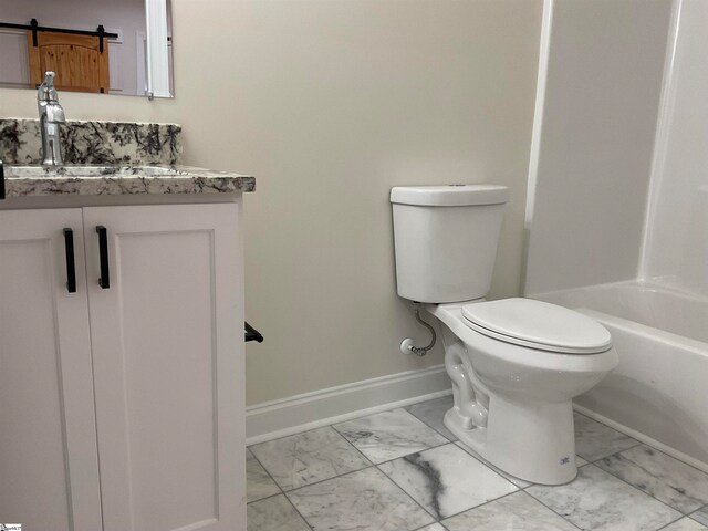 bathroom featuring vanity, tile floors, and toilet