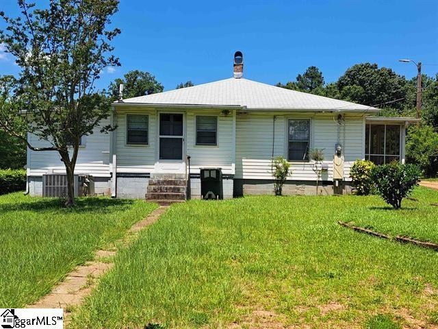 back of property featuring a lawn