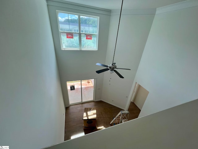 foyer with ceiling fan and a towering ceiling