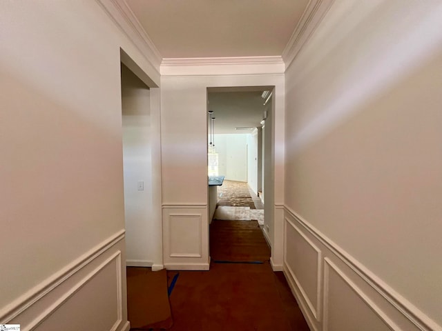 corridor featuring crown molding and dark colored carpet