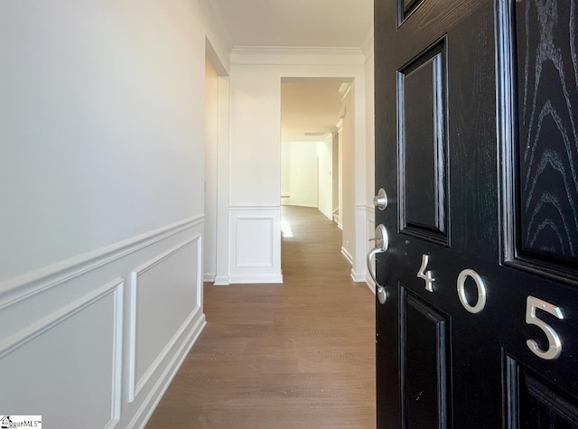 hall featuring hardwood / wood-style floors and crown molding