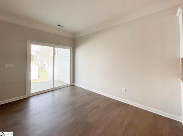 unfurnished room featuring visible vents, baseboards, ornamental molding, and dark wood finished floors