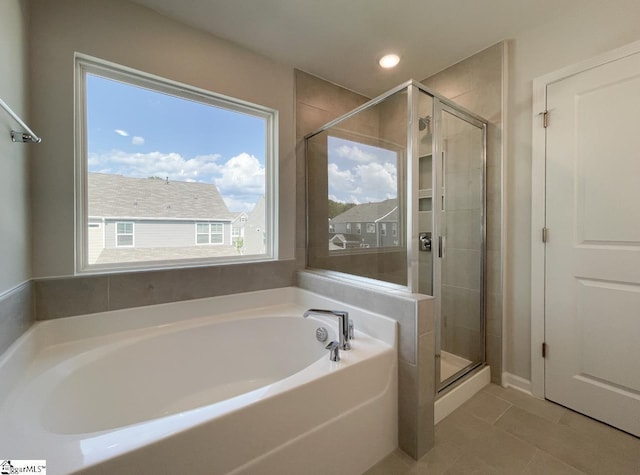 bathroom with a shower stall and a garden tub