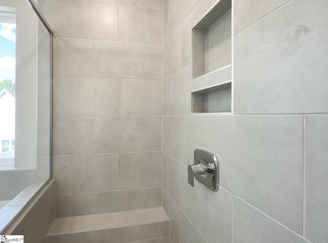 full bath featuring tiled shower