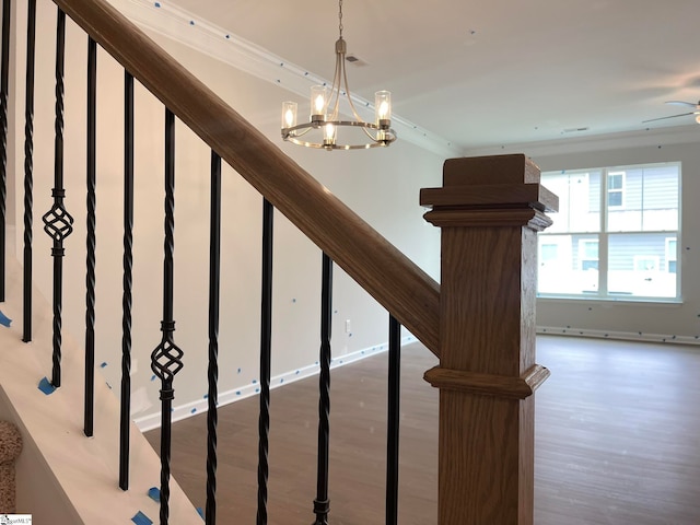 stairway featuring hardwood / wood-style floors and a chandelier