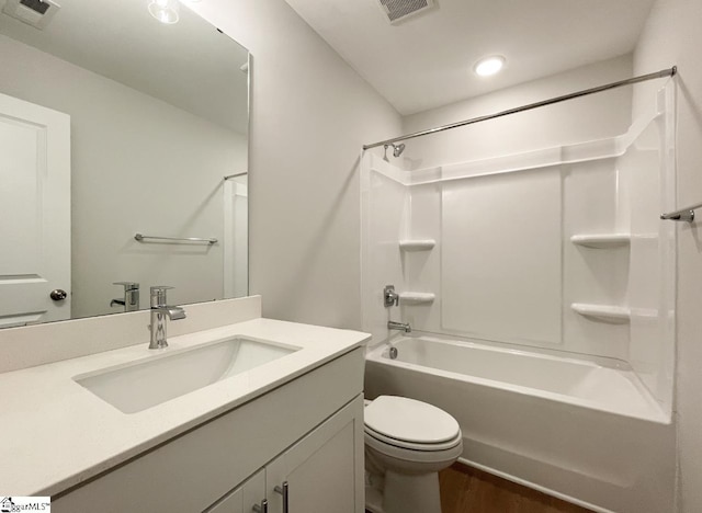 full bathroom with visible vents, toilet, vanity, and wood finished floors