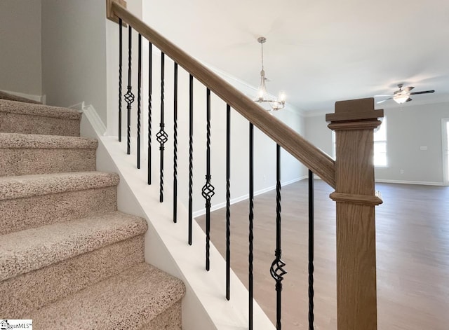 stairs featuring ornamental molding, baseboards, a ceiling fan, and wood finished floors