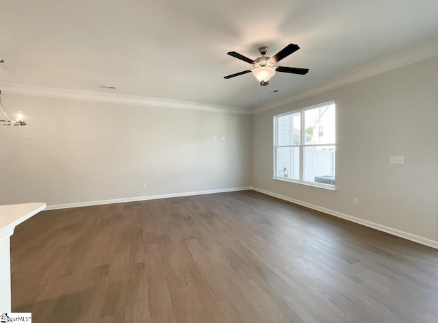 unfurnished room featuring dark wood-style floors, baseboards, ornamental molding, and ceiling fan with notable chandelier