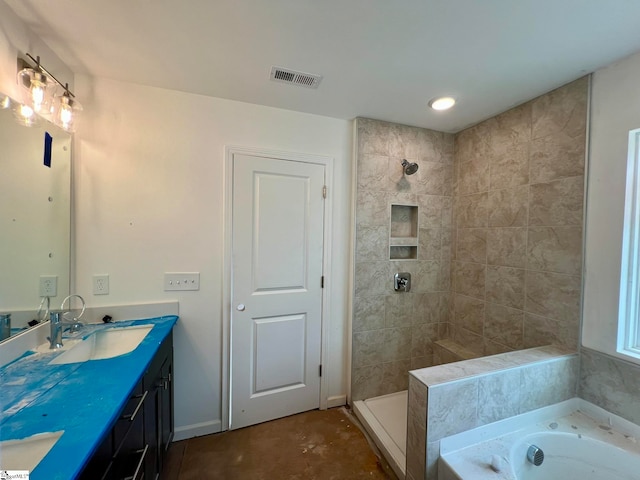 bathroom with double vanity and separate shower and tub