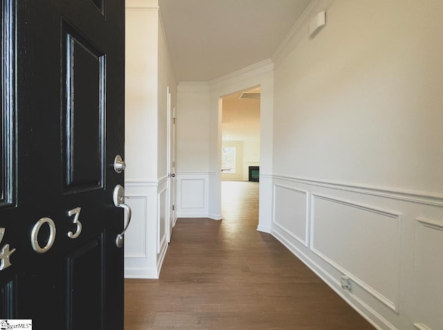 hall featuring crown molding and dark hardwood / wood-style flooring