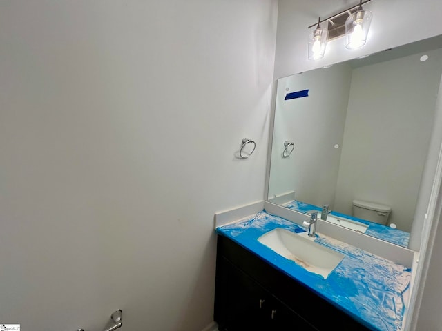 bathroom with toilet and vanity