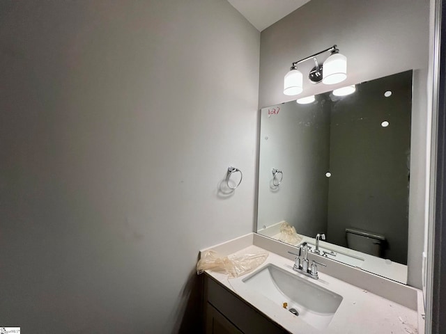 bathroom featuring vanity and toilet