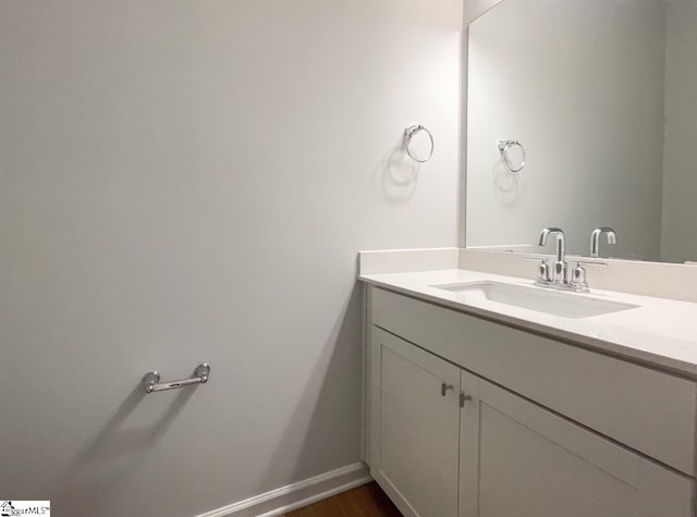 bathroom with hardwood / wood-style flooring and vanity