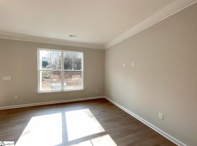 unfurnished room featuring ornamental molding and dark hardwood / wood-style floors