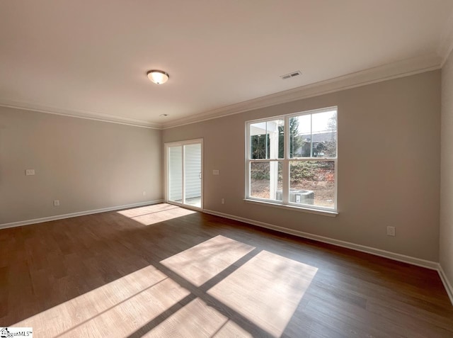 spare room with dark wood-type flooring and ornamental molding