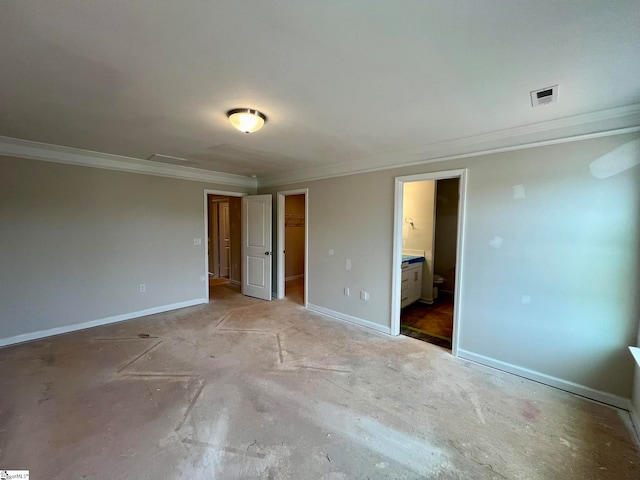 unfurnished bedroom with crown molding and ensuite bathroom