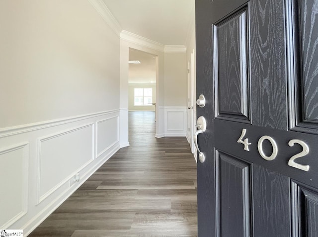 entryway featuring dark hardwood / wood-style flooring and ornamental molding