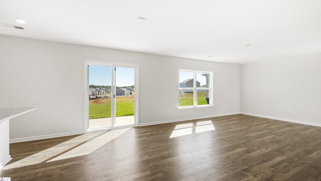 unfurnished living room featuring dark hardwood / wood-style flooring