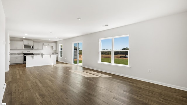 unfurnished living room featuring dark hardwood / wood-style flooring