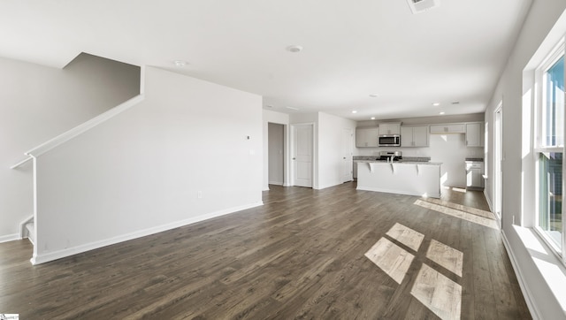 unfurnished living room featuring dark hardwood / wood-style floors