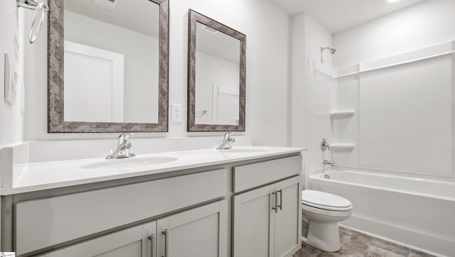 full bathroom with toilet, vanity, and washtub / shower combination