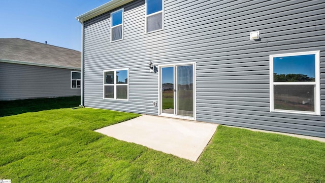 rear view of house featuring a patio and a lawn