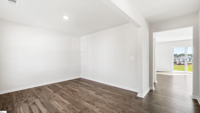 spare room featuring dark hardwood / wood-style floors