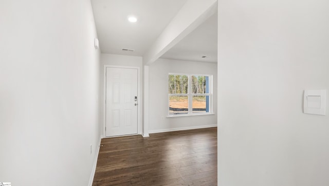 entrance foyer featuring dark hardwood / wood-style floors and beam ceiling