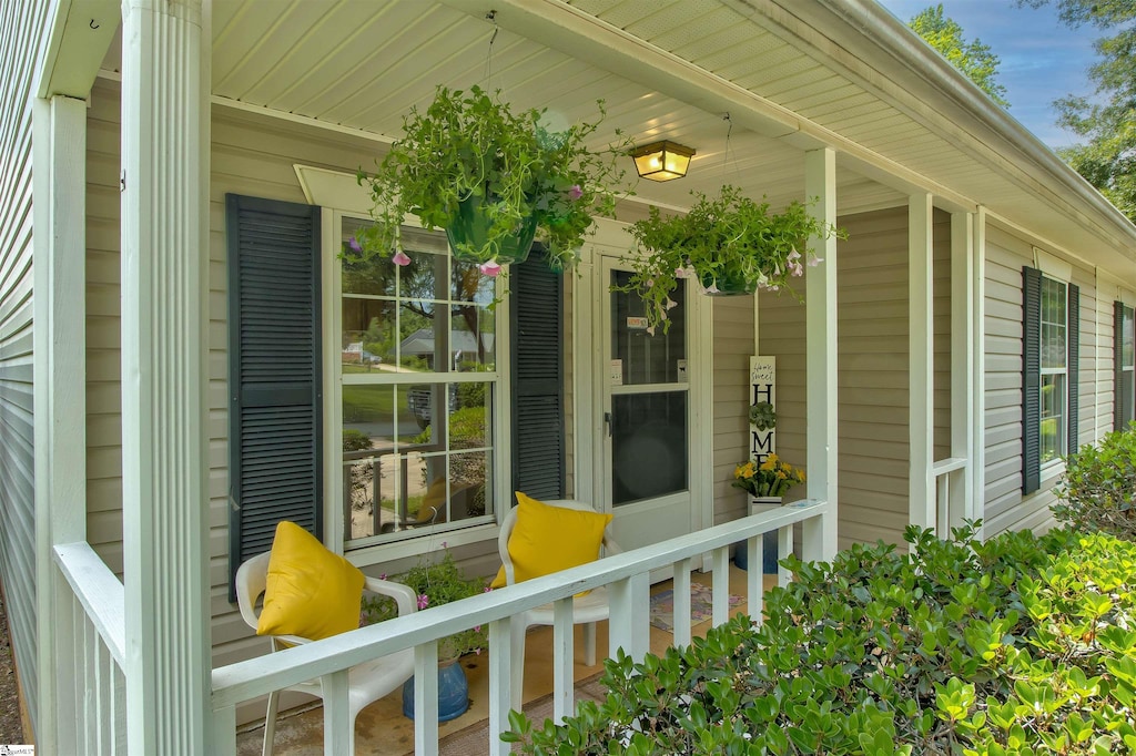 view of exterior entry featuring covered porch