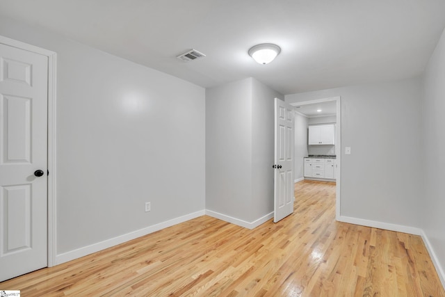 empty room with light hardwood / wood-style flooring