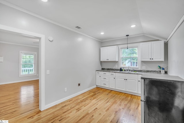 kitchen featuring white cabinets, sink, ornamental molding, and light hardwood / wood-style flooring