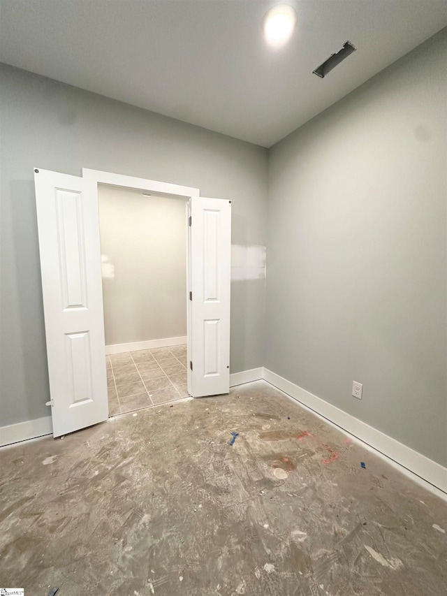 spare room with baseboards