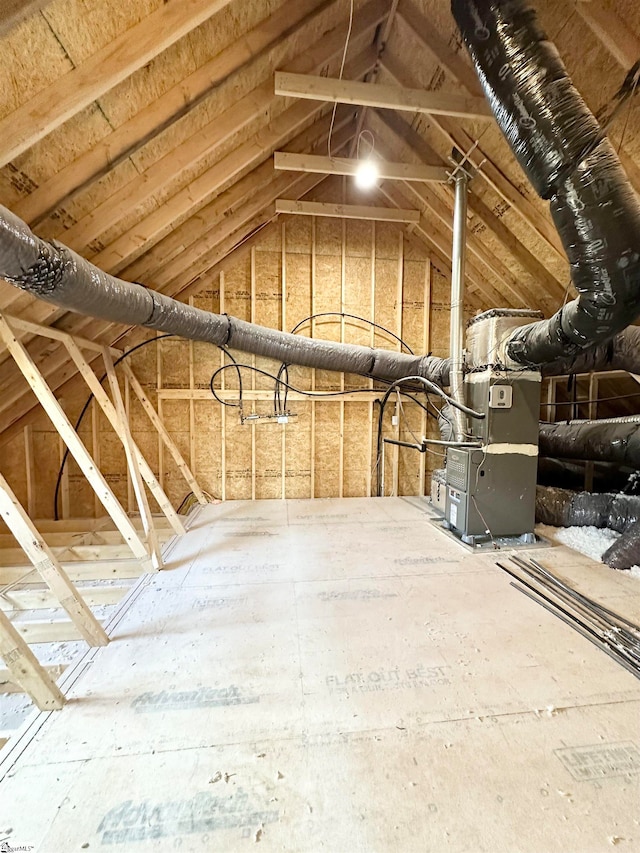 unfinished attic featuring heating unit