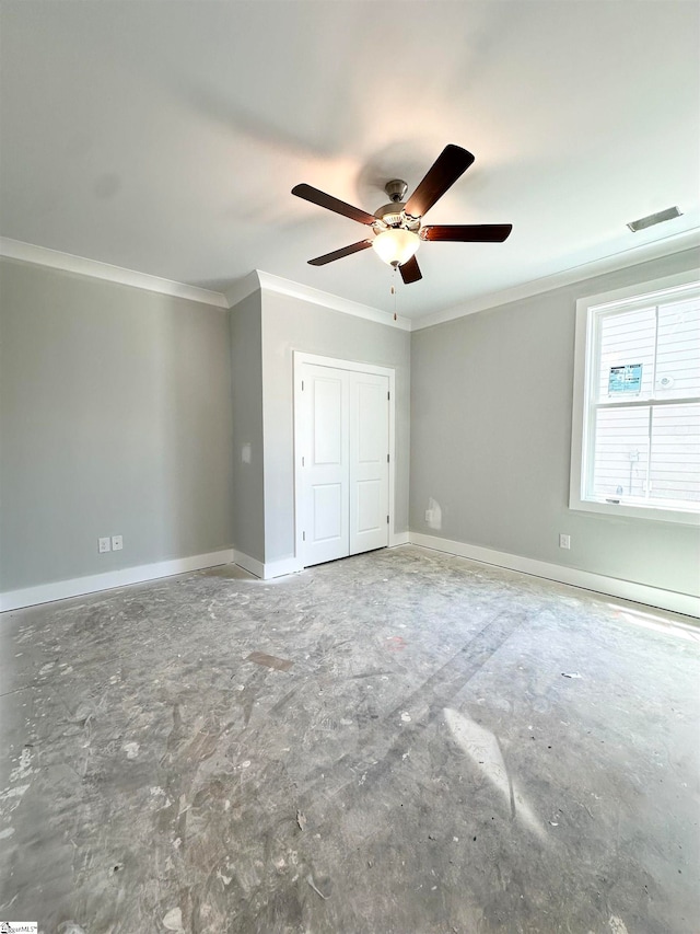 unfurnished bedroom with visible vents, a closet, crown molding, baseboards, and ceiling fan