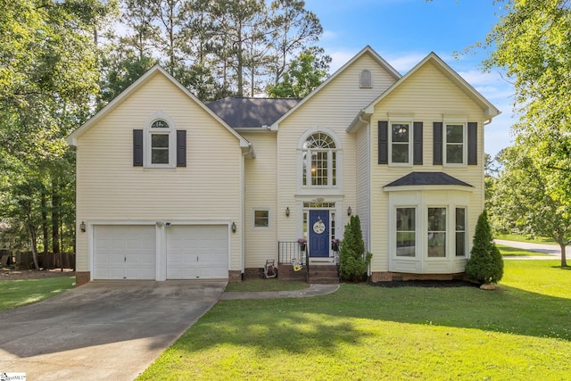 view of front of property featuring a front lawn and a garage