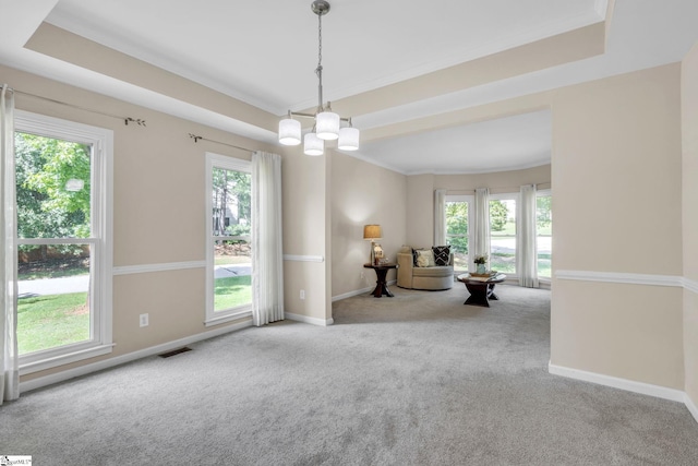 interior space with ornamental molding, a healthy amount of sunlight, and an inviting chandelier