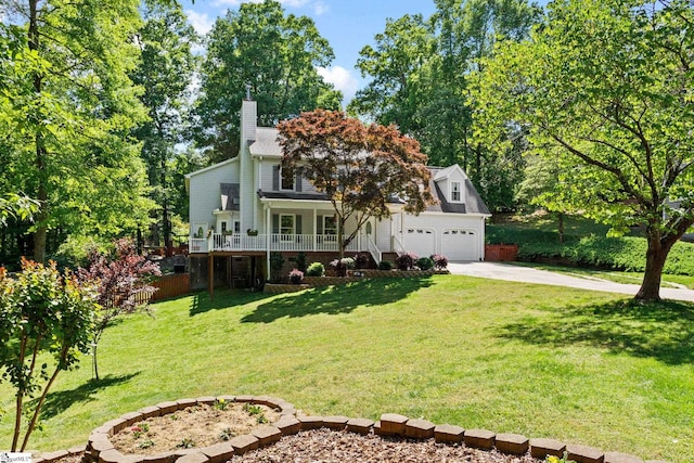 view of front of home featuring a garage, a front lawn, and a porch