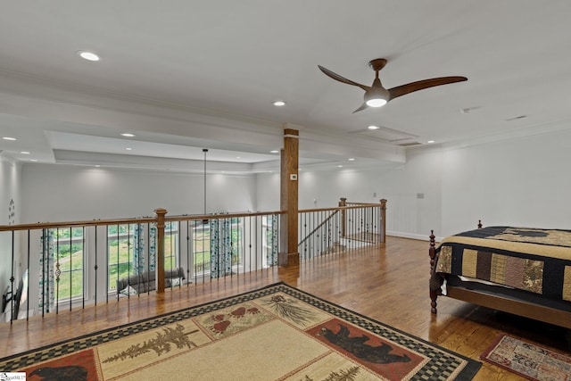 interior space with a tray ceiling, crown molding, and hardwood / wood-style flooring