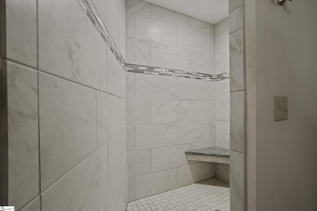 bathroom with a tile shower