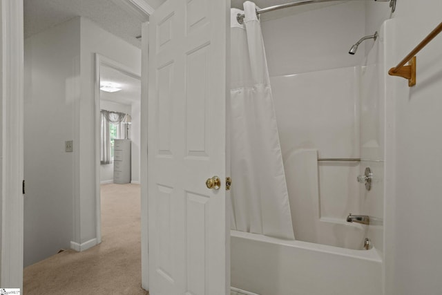 bathroom featuring shower / bath combo with shower curtain and a textured ceiling