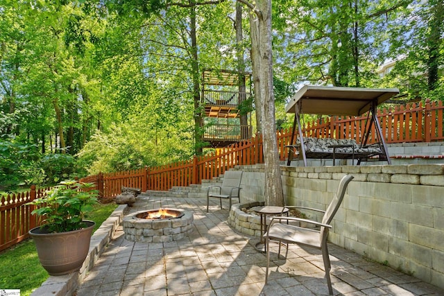 view of patio featuring a fire pit and a gazebo