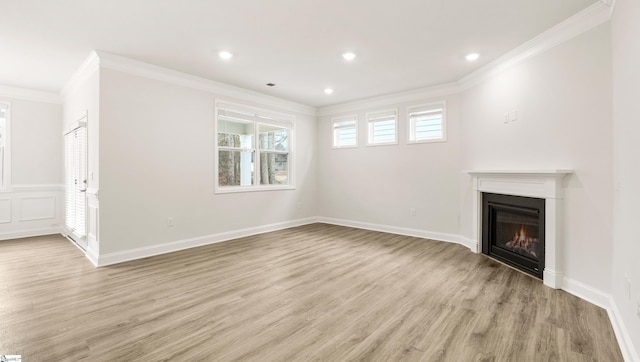 unfurnished living room featuring crown molding and light hardwood / wood-style flooring