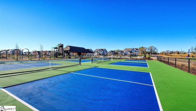 view of tennis court featuring basketball court