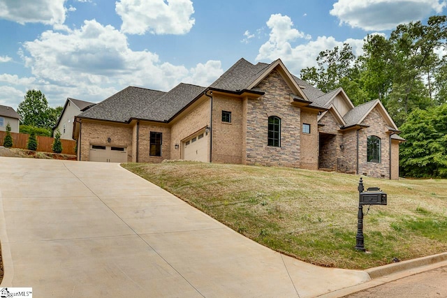 french country inspired facade featuring a front lawn and a garage