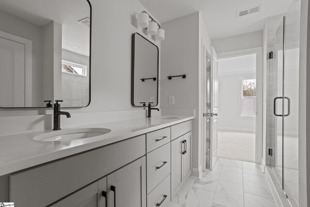 bathroom featuring vanity and a shower with shower door