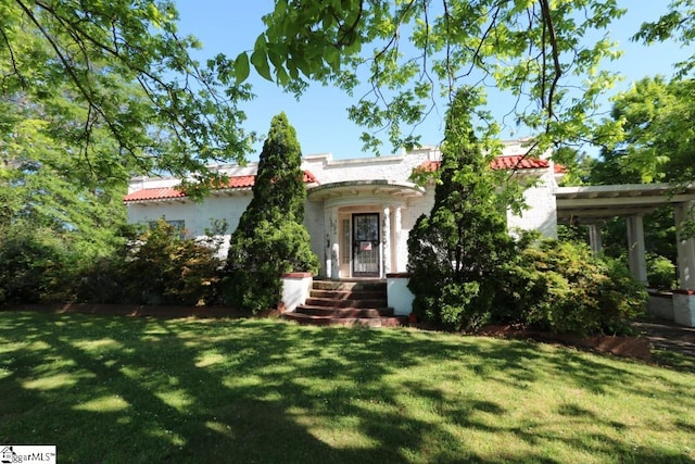 mediterranean / spanish house with a front lawn